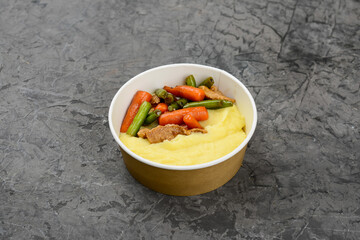 bowl with potatoes, vegetables and meat