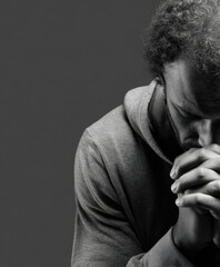 Man in deep prayer seeking solace during a moment of reflection in black and white