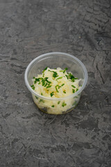 sauerkraut in a single pink dish on a gray background vertical photo