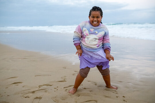 Smiling child in wet clothes from the ocean