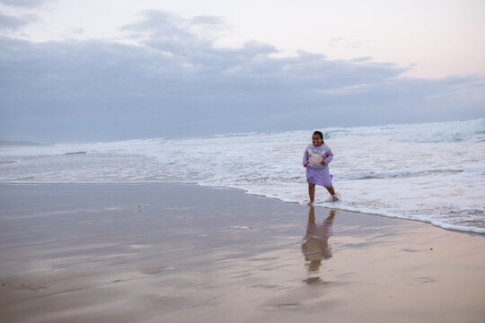 Young girl playing in the waves