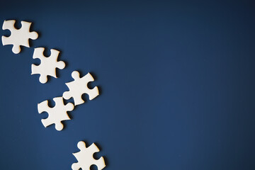 Clean puzzle elements on the background. Empty puzzle piece on the table. Teamwork concept.