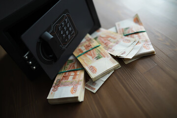 money in a residential safe close-up photo. Deposit in cash. Russian rubles are in the safe