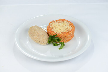 Bulgur porridge with cutlet on a white plate