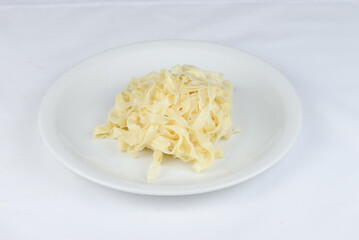 sauerkraut on a white plate on a white background