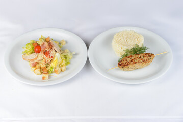 lunch salad with rice and kebab on a white background