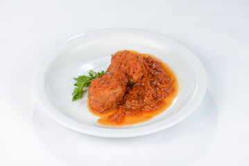 meatballs with sauce on a white plate