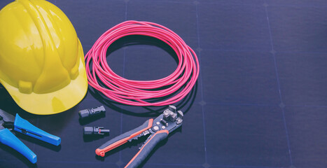 Solar Installation Tools and Safety Equipment on Solar Panel Surface