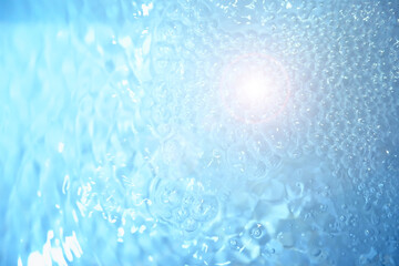 Bubbles and seething water in the light of sunlight.Blue water texture.