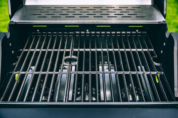 Barbecue gas grill in stainless steel. Black modern stainless portable BBQ barbecue grill outdoor.
