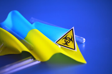Ukrainian flag biohazard and test tubes. Assistance to Ukraine in biolaboratories. Western...