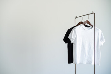 Minimal clothing setup with black and white T-shirts on hangers