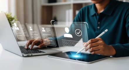 A person uses a laptop and tablet to review candidate profiles and data on a digital interface for recruitment