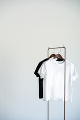 Minimal clothing setup with black and white T-shirts on hangers