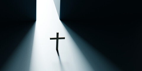 Wooden Christian cross standing under dramatic ray of light from an opening. Concept of faith,...