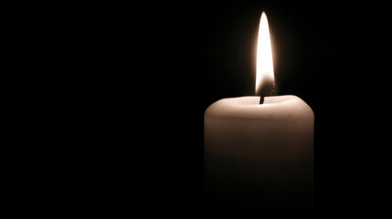 Mourning candle softly glowing in the dark evokes remembrance and reflection