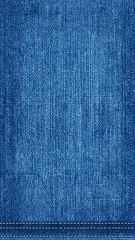 Close-up of textured blue denim fabric with white stitching detail