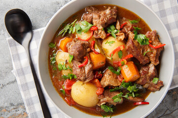 Semur Daging Indonesian braised beef with spices and sweet soy sauce closeup in the bowl on the table. Horizontal top view from above