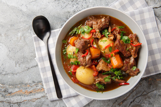 Semur Daging or Sweet Beef Stew closeup in the bowl on the table. Horizontal top view from above