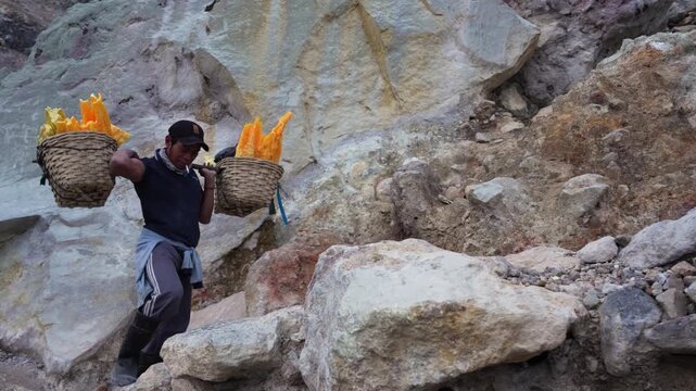 Extremely heavy sulfur load carried by a miner out of Kawah Ijen Crater