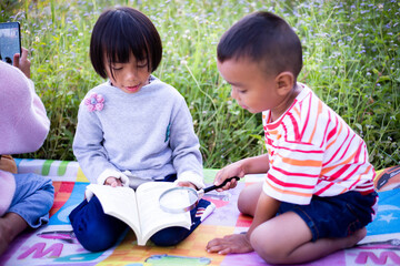 Kids exploring in forest with a magnifying glass