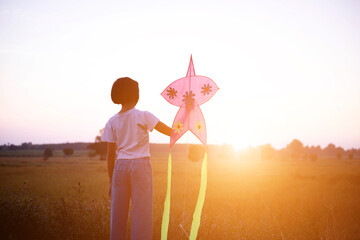 Child flying a multicolored kite outside