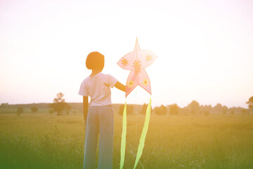 Child flying a multicolored kite outside