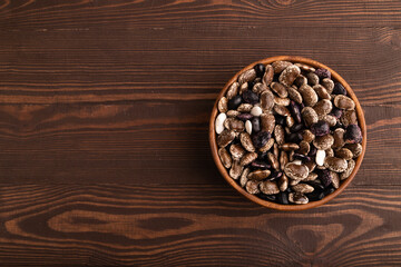 wooden bowl with Kidney beans on brown wooden, top view, copy space