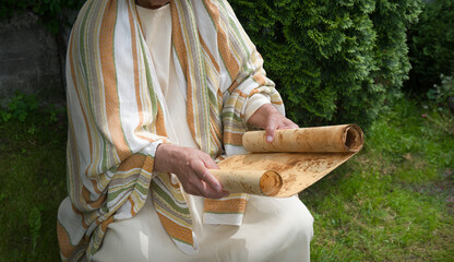 Old man reading the scroll
