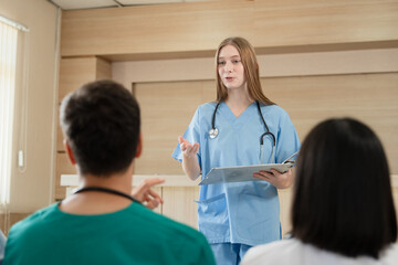 Team Doctor listening medical Caucasian woman student present at hospital	