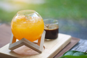 A refreshing iced orange drink garnished