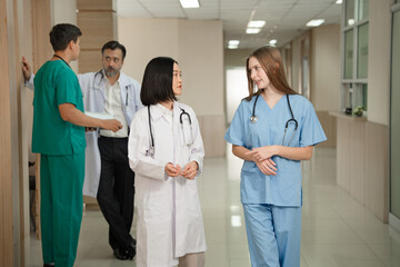 Caucasian doctor woman working and talking with major Asia woman medical student at hospital	
