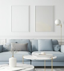 A minimalist living room with a blue sofa. two framed posters. a coffee table. and a lamp