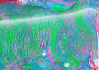 Abstract blue green ebru background. Bright iridescences of paint on the water. A creative artistic background for graphic design. Multi-colored shades of colors mixing. Fluid texture Contemporary art