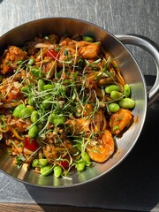Colorful Asian Stir-Fry with Chicken and Edamame in Metal Bowl