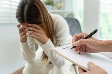 woman with mental health problems is consulting. psychiatrist is recording the patient's condition...