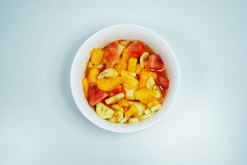 Fresh Colorful Fruit Salad in White Bowl on Clean White Background – Healthy Vegan Snack or Dessert