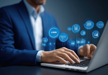 Businessman using laptop for loan applications.  Holographic loan icons surround the laptop