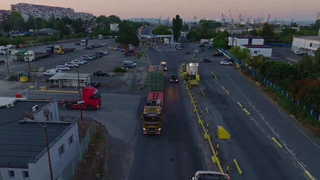 Heavy-haul Trailer With Power Transformer Leaving The BMF Port Burgas At Sunrise In Bulgaria. - aerial shot
