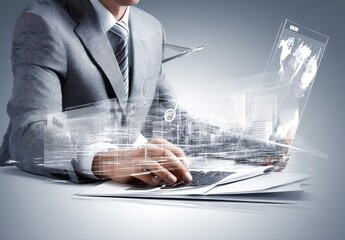 Businessman working on a laptop with futuristic, overlayed data