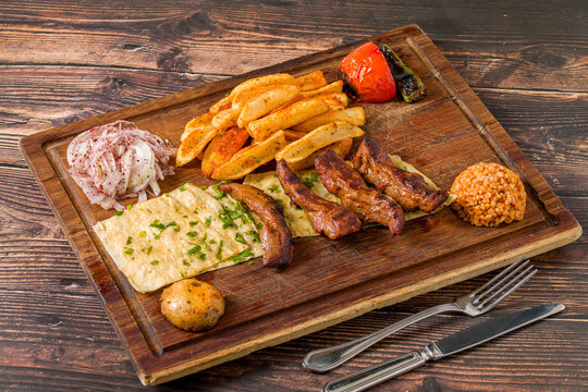 Grilled lamb fillet or Lamb Kusleme served with fries, lavash bread and bulgur pilaf