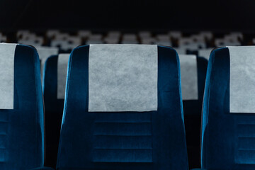 Blue chairs in an empty movie theater, low light