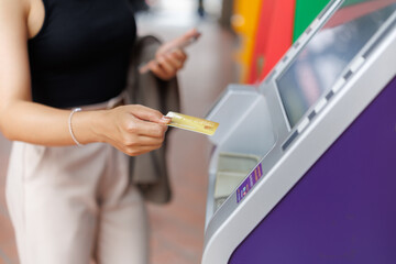 Businesswoman using credit card at atm for financial transaction