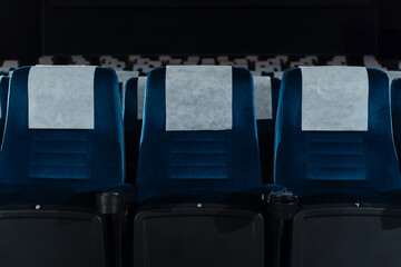 Blue chairs in an empty movie theater, low light