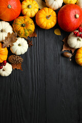 Vertical Autumn composition with pumpkins on a wooden background, top view. Harvest Festival, Thanksgiving and Halloween