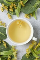 Close-up of green tea with fragrant linden in white cup