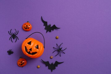Halloween pumpkin basket, bats and spiders. Top view, space for text