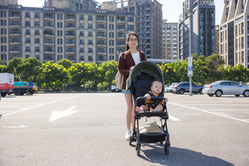 Obraz premium Mum walk with baby son on stroller