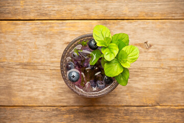 Blueberry mojito on the rustic wooden background. Selective focus.