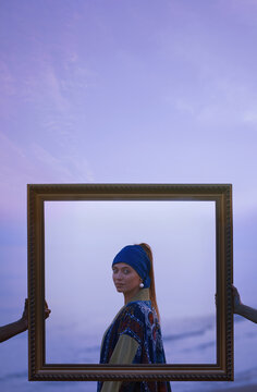 Elegant person in chapan and turban framed against the sky outdoors